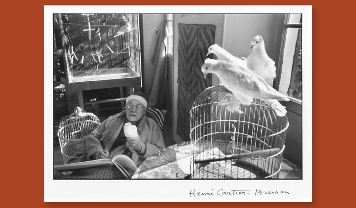 photograph of a woman with her pet pigeon