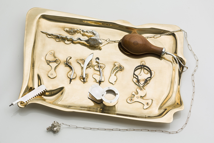 cryptic gold trinkets on a gold tray