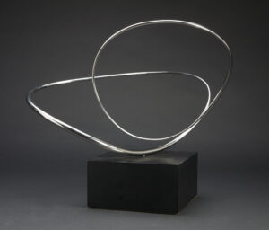 simple silver wire loop sculpture on black block