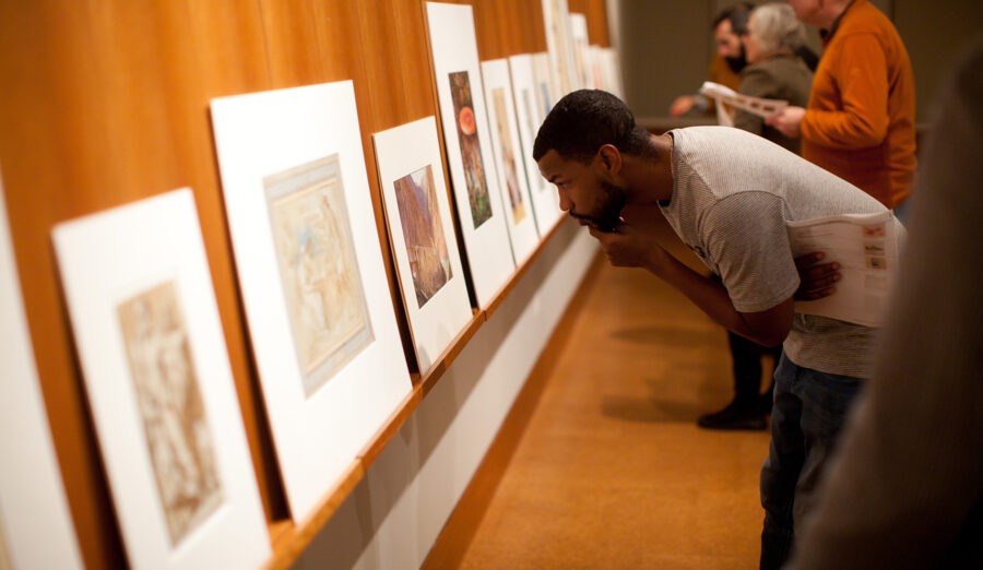 A young man examines a print