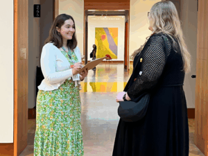 Bolz Center for Arts Administration graduate student Anna Michalski (left) surveys a gallery visitor as part of her year-long project studying audiences at the Chazen Museum of Art.