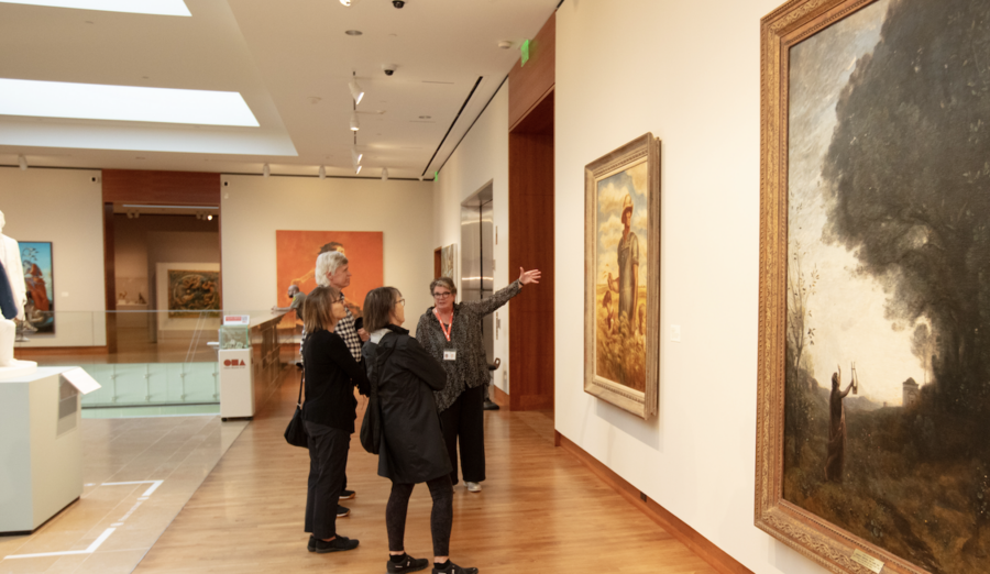 tour group looks at paintings